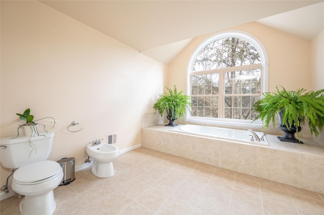 full bath featuring visible vents, toilet, a bidet, lofted ceiling, and tile patterned floors