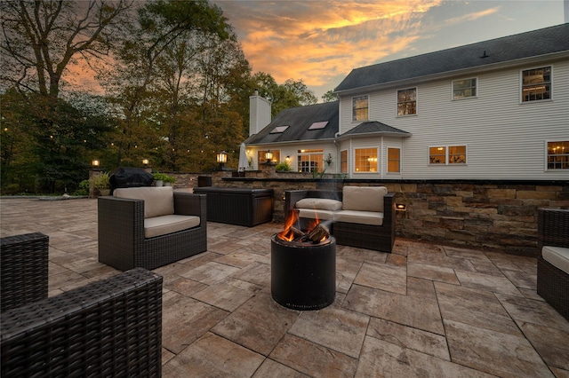 view of patio featuring an outdoor living space with a fire pit and grilling area