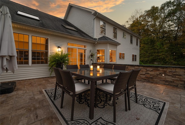 patio terrace at dusk with outdoor dining area