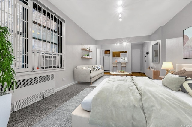 carpeted living area featuring baseboards, radiator, plenty of natural light, and vaulted ceiling