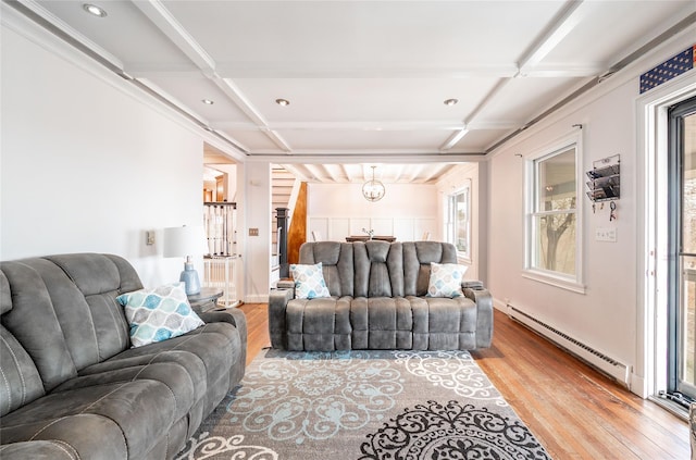 living area featuring a notable chandelier, wood finished floors, coffered ceiling, and a baseboard radiator