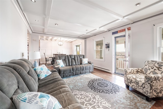 living area featuring a baseboard heating unit, beam ceiling, coffered ceiling, and wood finished floors