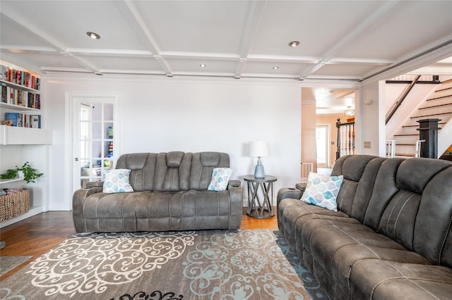 living room with stairway, coffered ceiling, and wood finished floors