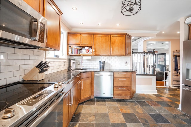 kitchen featuring brown cabinets, a sink, backsplash, stainless steel appliances, and crown molding