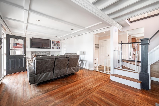 living room featuring built in shelves, stairway, beamed ceiling, hardwood / wood-style floors, and coffered ceiling