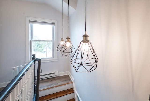 staircase with baseboards, a baseboard heating unit, and lofted ceiling