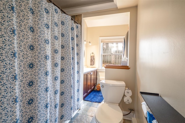 bathroom with curtained shower, toilet, and stone finish floor