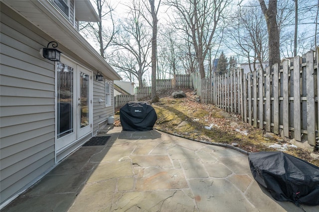 view of patio with area for grilling and a fenced backyard