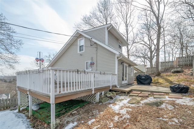 view of side of property featuring a wooden deck and fence