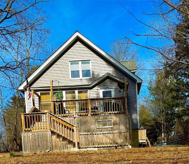 back of property featuring a deck and stairway