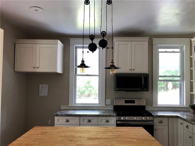 65 Boris Rd, Bloomingburg, NY 12721 - kitchen with gas stove, wood counters, white cabinets, and hanging light fixtures