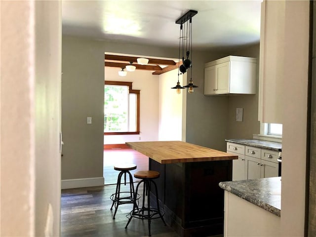 65 Boris Rd, Bloomingburg, NY 12721 - kitchen featuring white cabinetry, a breakfast bar area, dark wood finished floors, and butcher block counters
