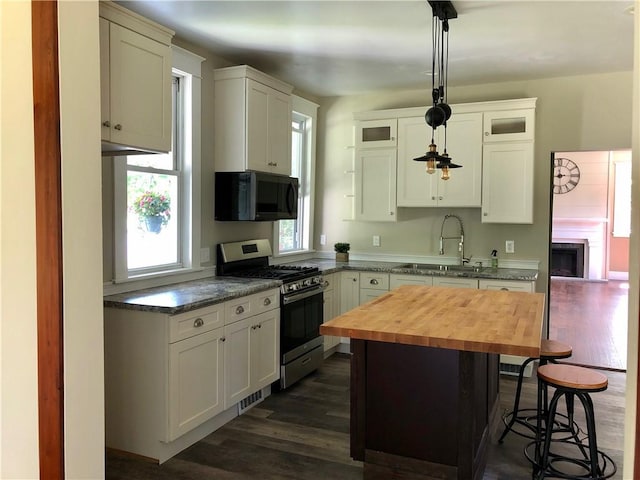 65 Boris Rd, Bloomingburg, NY 12721 - kitchen with a sink, wood counters, dark wood finished floors, black microwave, and stainless steel gas range