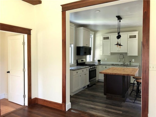 65 Boris Rd, Bloomingburg, NY 12721 - kitchen featuring dark wood finished floors, a sink, black microwave, gas range, and butcher block counters