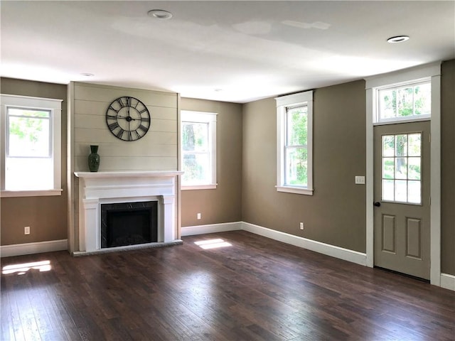 65 Boris Rd, Bloomingburg, NY 12721 - unfurnished living room with dark wood finished floors, a fireplace with raised hearth, and baseboards