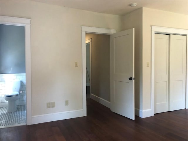 65 Boris Rd, Bloomingburg, NY 12721 - unfurnished bedroom featuring connected bathroom, wood finished floors, a closet, and baseboards