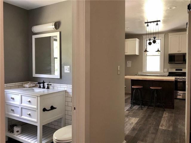 65 Boris Rd, Bloomingburg, NY 12721 - bathroom featuring vanity, toilet, and wood finished floors