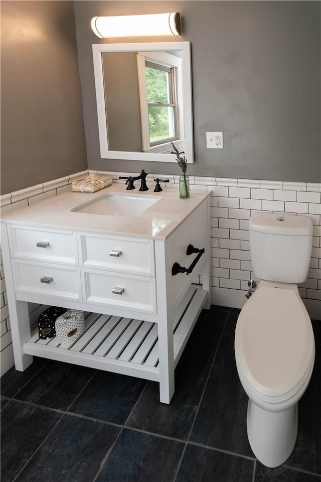 65 Boris Rd, Bloomingburg, NY 12721 - bathroom featuring vanity, wainscoting, tile patterned floors, toilet, and tile walls