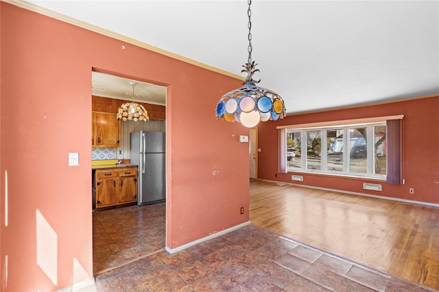 unfurnished dining area featuring baseboards