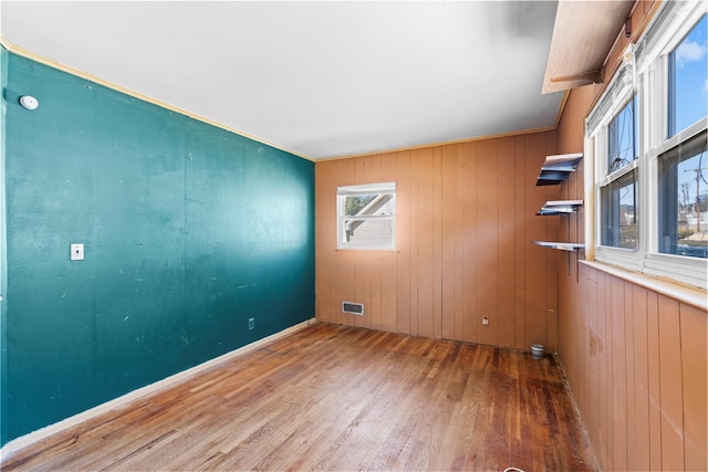 unfurnished room featuring visible vents and wood finished floors