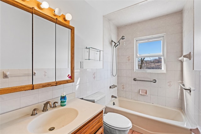 bathroom with shower / bath combination, toilet, tile walls, and vanity