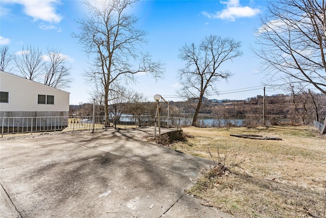 view of yard featuring fence and a water view