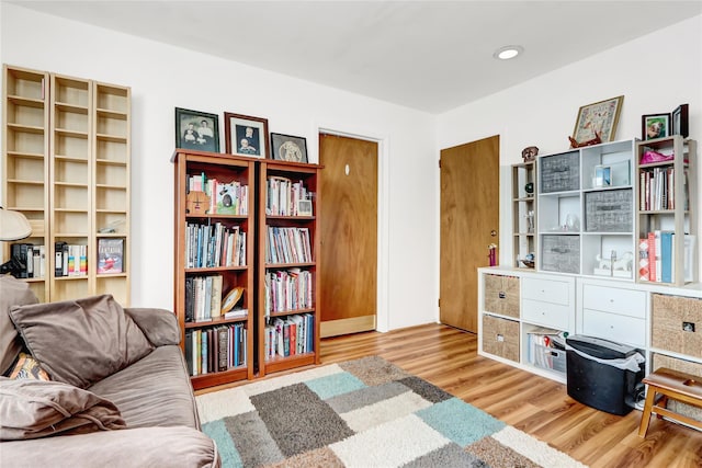 living area with recessed lighting and wood finished floors