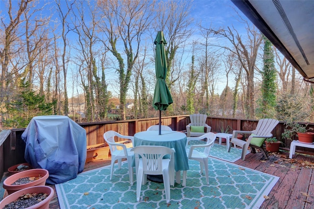 wooden terrace with grilling area and outdoor dining space