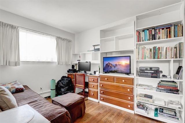 living area featuring wood finished floors and a baseboard radiator