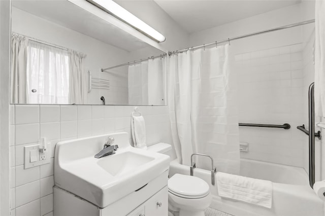 full bath with shower / bath combo with shower curtain, toilet, tasteful backsplash, tile walls, and vanity