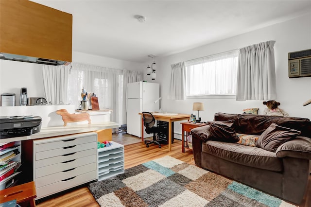 living room featuring light wood-style flooring and a wall mounted air conditioner