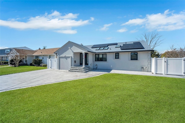 view of front of property with a front yard, a gate, and a garage