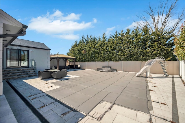 view of patio featuring a gazebo, a fenced backyard, and entry steps