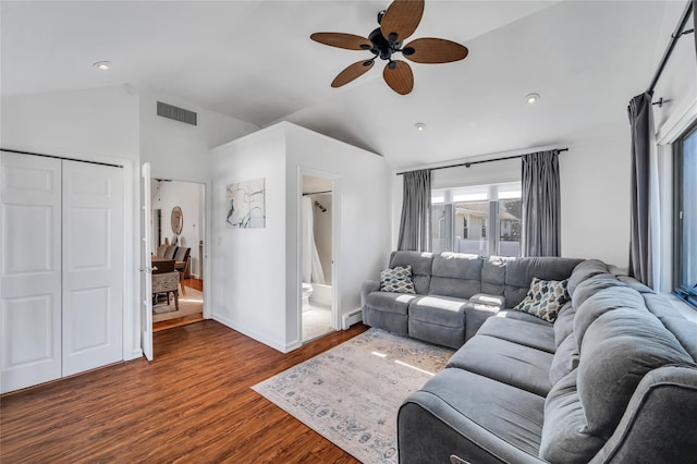 living room featuring wood finished floors, visible vents, baseboards, vaulted ceiling, and a baseboard heating unit