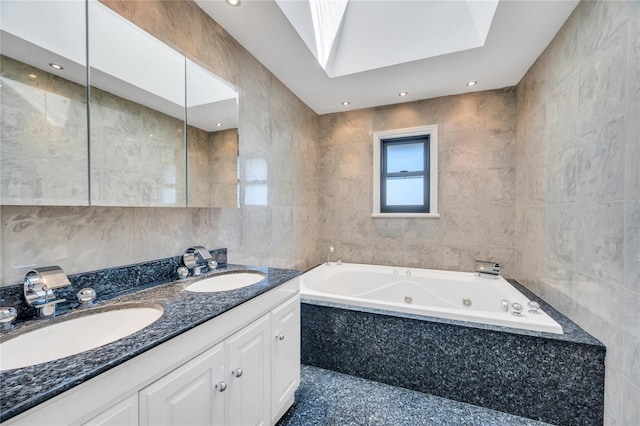 bathroom with a sink, tile walls, and a tub with jets