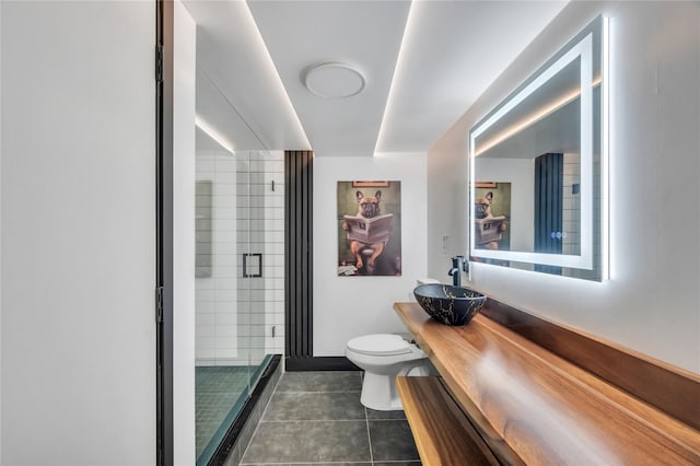 full bathroom featuring tile patterned flooring, toilet, vanity, and a stall shower