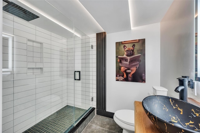 full bathroom featuring tile patterned flooring, a shower stall, toilet, and vanity