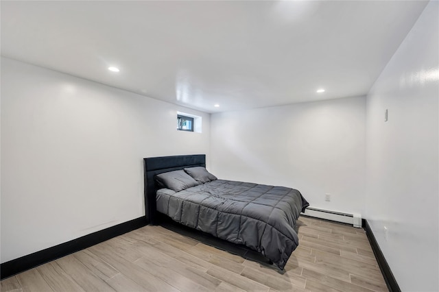 bedroom with recessed lighting, light wood-style floors, baseboards, and baseboard heating