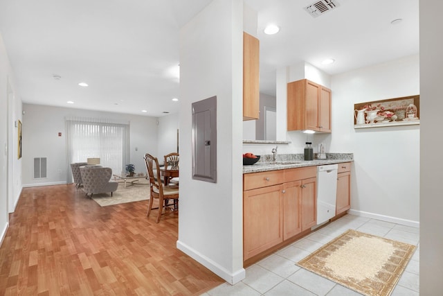 kitchen with light wood finished floors, visible vents, dishwasher, and open floor plan