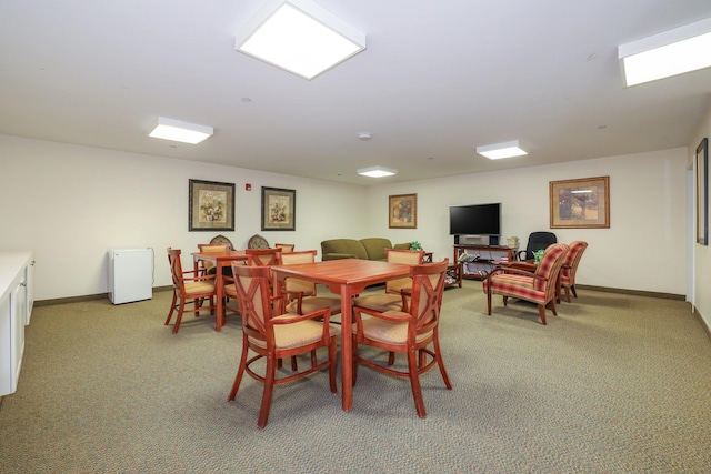 dining area with light colored carpet and baseboards