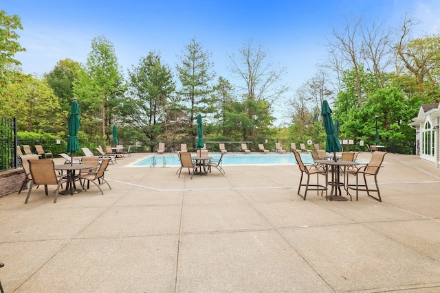 community pool featuring a patio area and fence