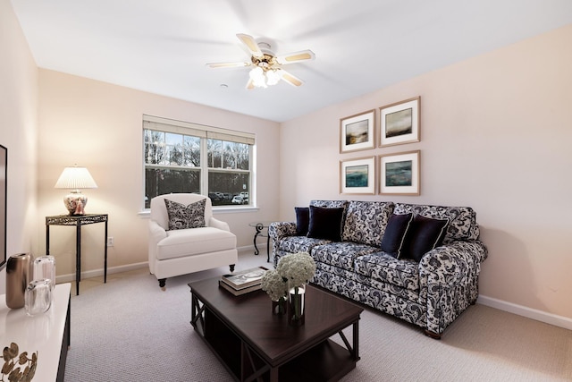 living room featuring baseboards, ceiling fan, and carpet flooring