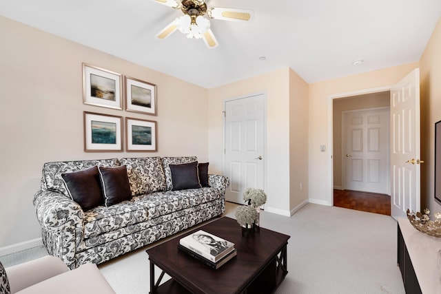 living room with baseboards, carpet, and ceiling fan