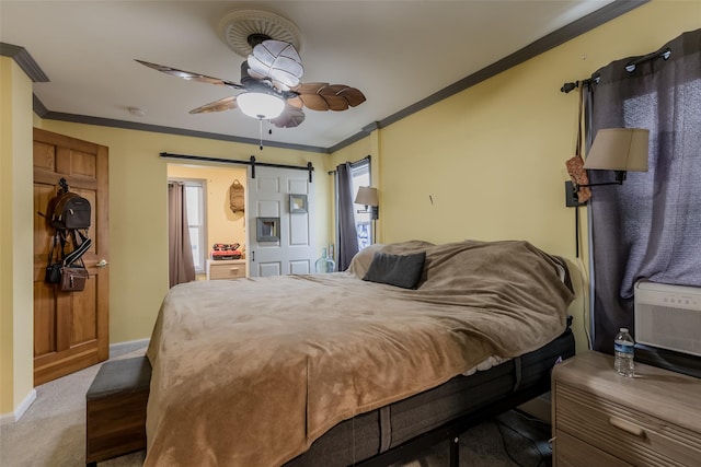 bedroom featuring baseboards, ceiling fan, ornamental molding, a barn door, and carpet flooring