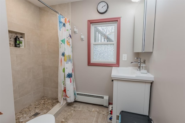 bathroom with a baseboard heating unit, toilet, vanity, and a stall shower