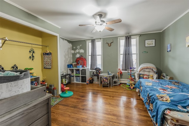 bedroom with a ceiling fan, wood finished floors, and ornamental molding