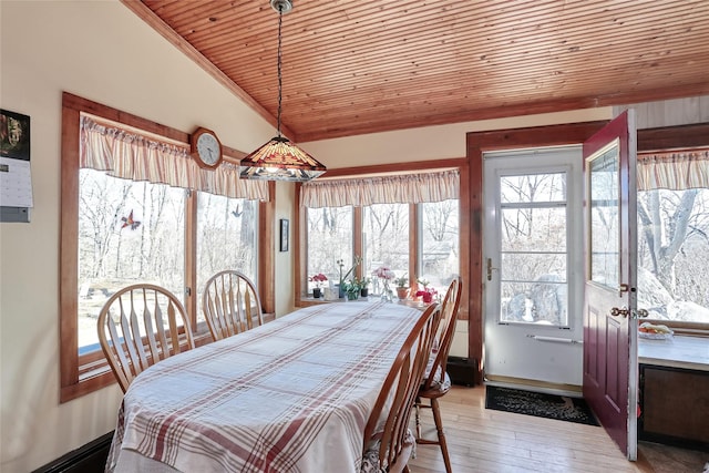 dining room with light wood finished floors, wood ceiling, baseboards, and vaulted ceiling