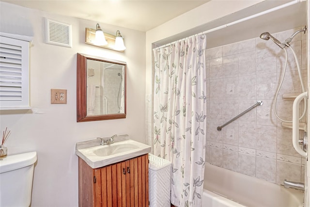 bathroom featuring visible vents, vanity, toilet, and shower / tub combo