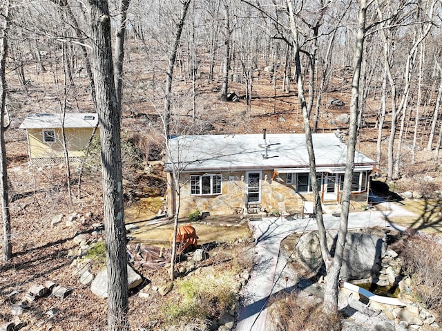 view of front of house with a patio and stone siding