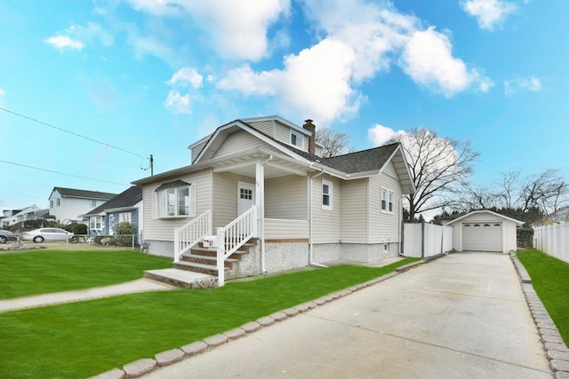 bungalow-style house with an outbuilding, a front yard, fence, concrete driveway, and a garage